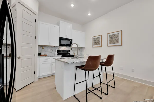 a kitchen with a stove cabinets and a refrigerator