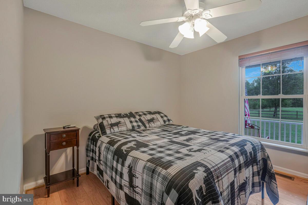 6115 Port Tobacco Road La Plata, MD 20646 - Photo 11 of 27 a bedroom with a bed and a chandelier
