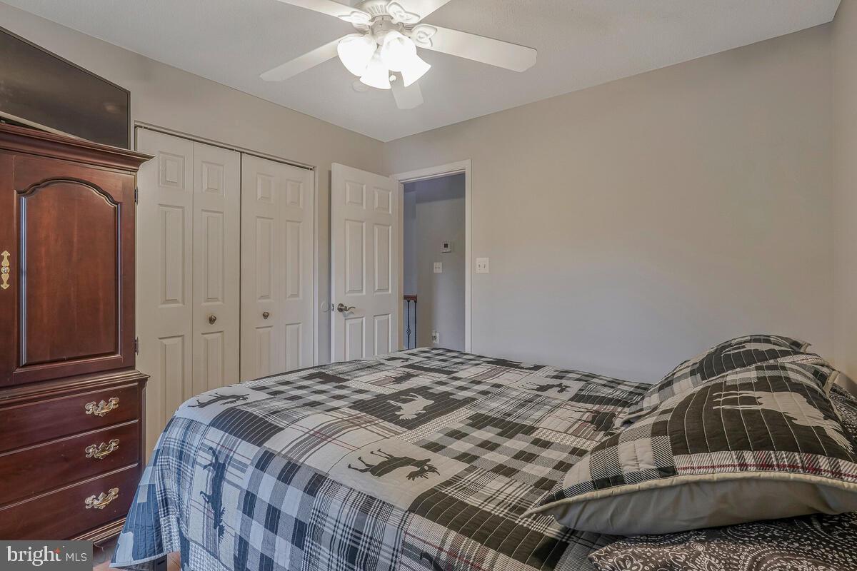 6115 Port Tobacco Road La Plata, MD 20646 - Photo 14 of 27 a bedroom with a bed and a chandelier