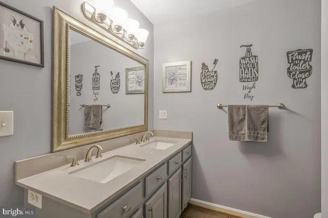 a bathroom with a sink vanity and mirror