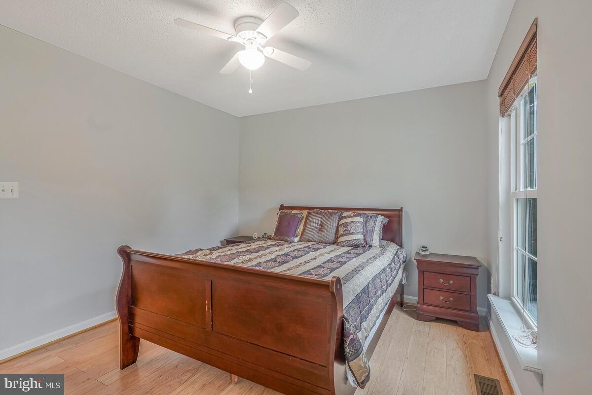 6115 Port Tobacco Road La Plata, MD 20646 - Photo 18 of 27 a bedroom with a bed and a chandelier