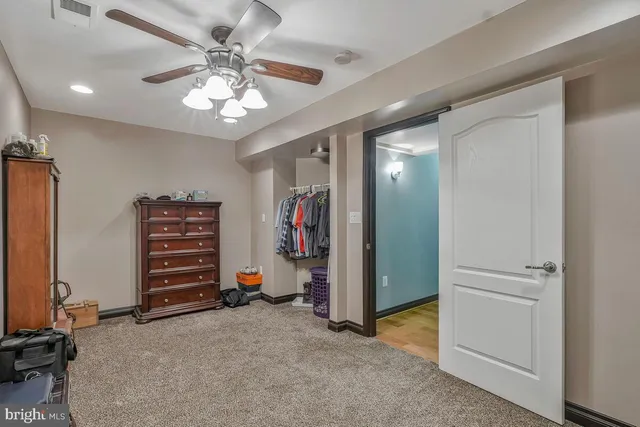 a view of washer and dryer with bathroom in the background