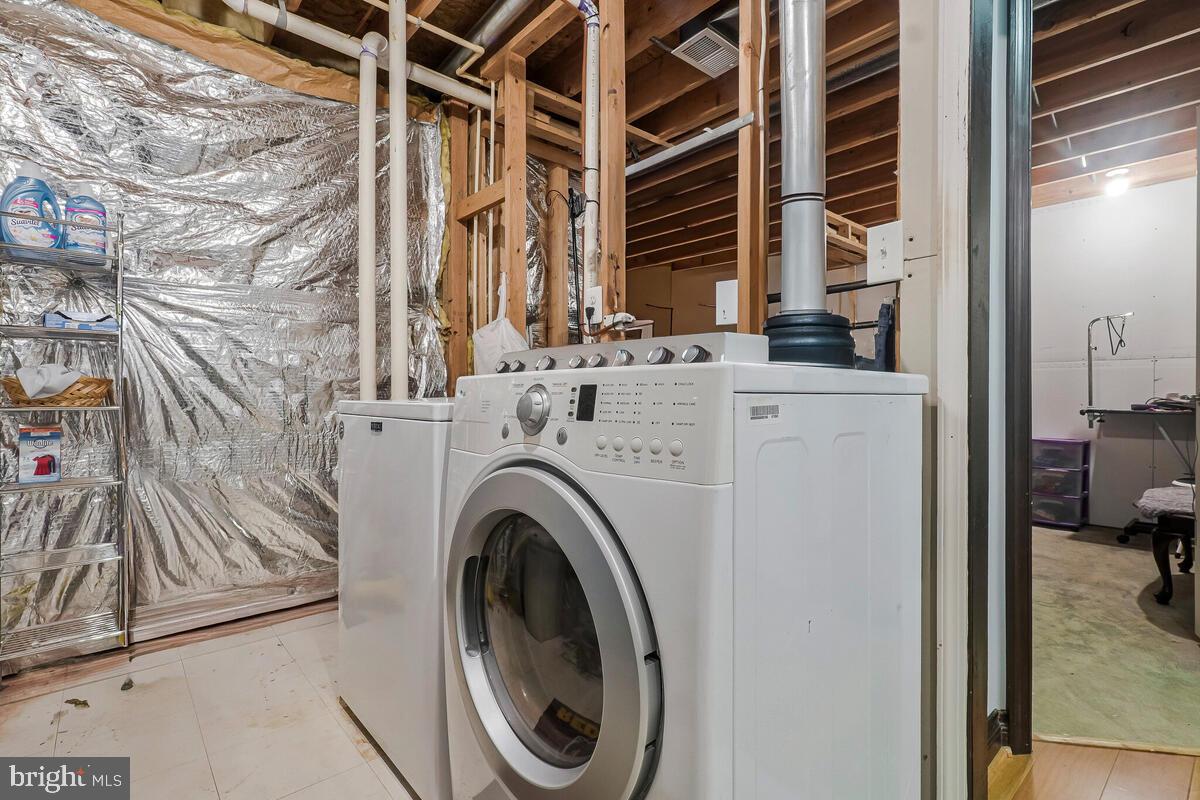 6115 Port Tobacco Road La Plata, MD 20646 - Photo 22 of 27 a view of washer and dryer with bathroom in the background