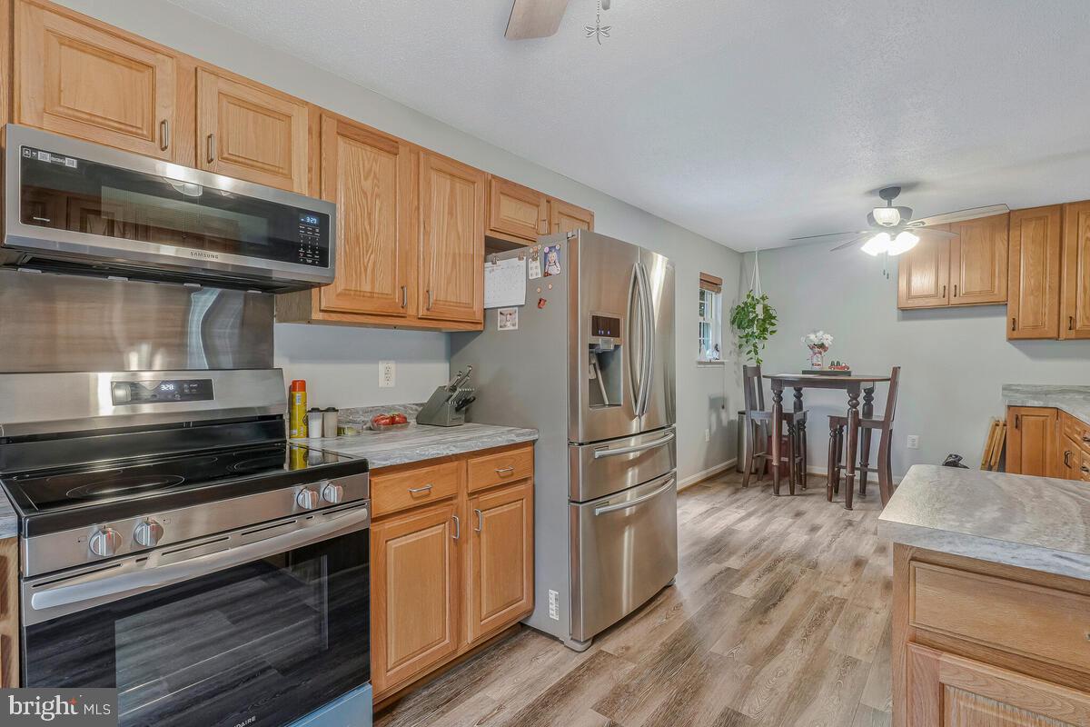 6115 Port Tobacco Road La Plata, MD 20646 - Photo 8 of 27 a kitchen with granite countertop a refrigerator stove top oven and sink