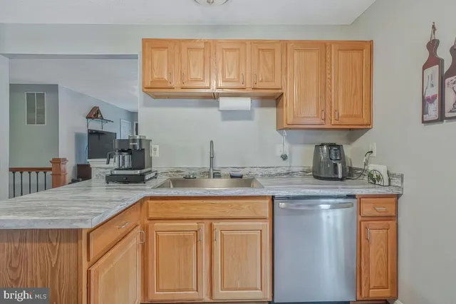 a kitchen with granite countertop a sink and cabinets