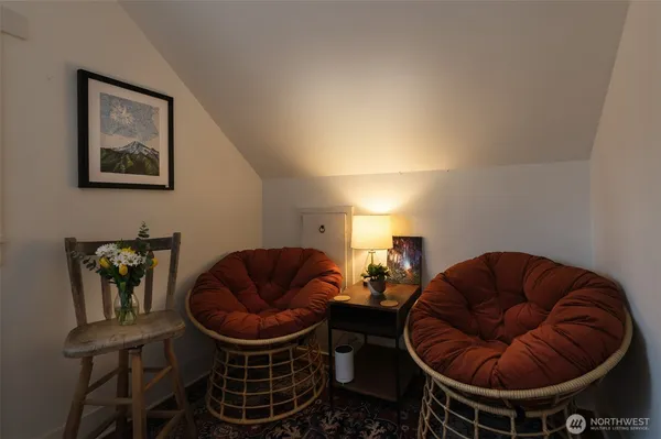 a living room with furniture a rug and blue walls