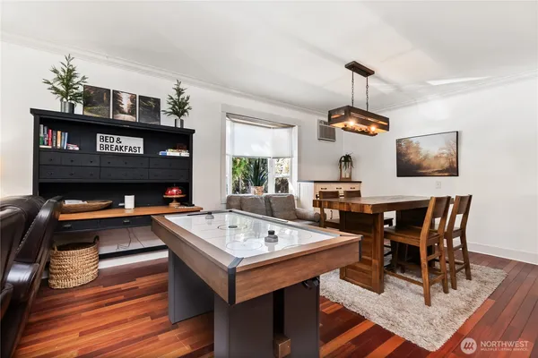 a view of a dining room with furniture and wooden floor