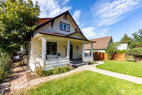 a view of a house with backyard porch and sitting area