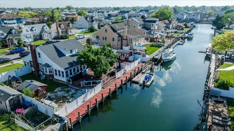 an aerial view of a house with a garden and lake view
