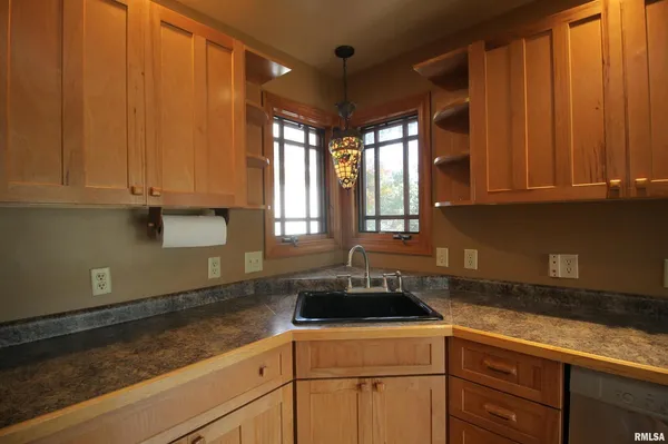 a kitchen with a sink cabinets and window
