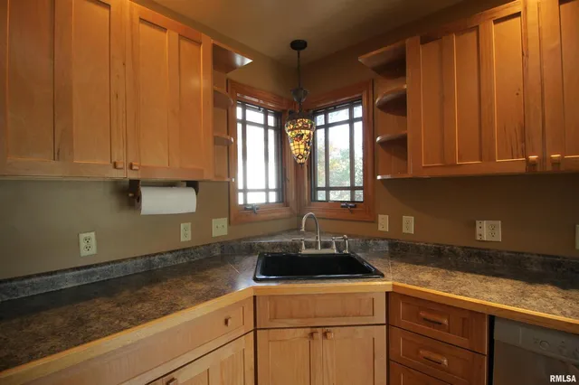 a kitchen with a sink cabinets and window