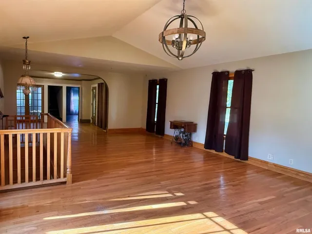 a view of a livingroom with a dinning area furniture and chandelier