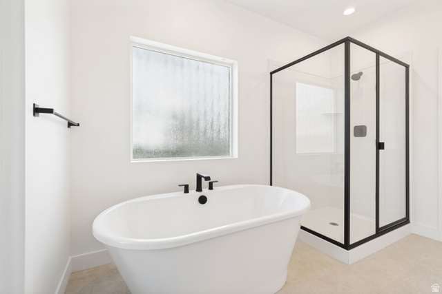 1351 Maple Circle Santaquin, UT 84655 - Photo 20 of 42 Freestanding oval bathtub with matte black fixtures, framed by a privacy window
