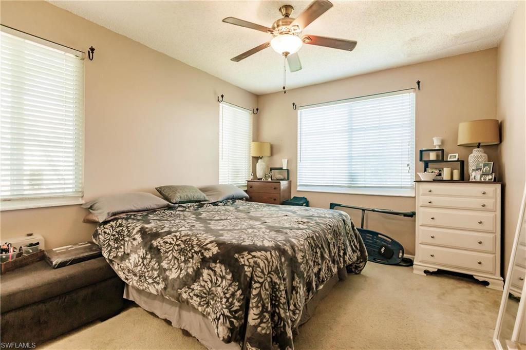 1230 Reserve Way, Unit 302 Naples, FL 34105 - Photo 11 of 28 a bedroom with a bed and a window