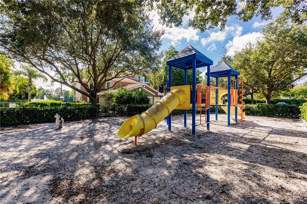 1230 Reserve Way, Unit 302 Naples, FL 34105 - Photo 19 of 28 a view of a house with a yard and sitting area