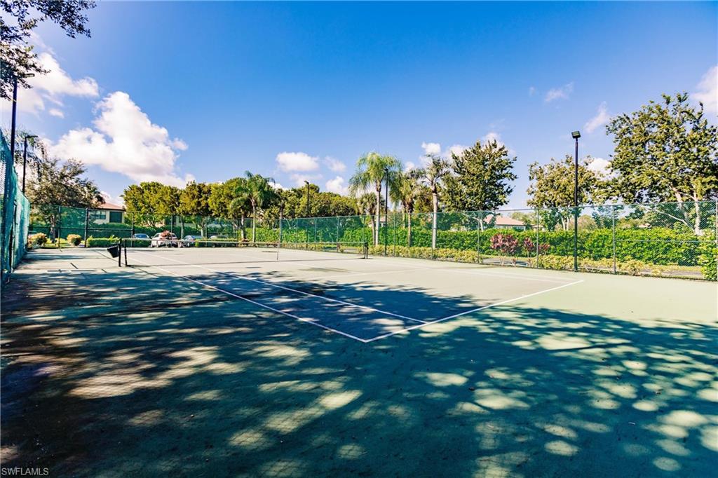 1230 Reserve Way, Unit 302 Naples, FL 34105 - Photo 20 of 28 a view of grassy field with trees