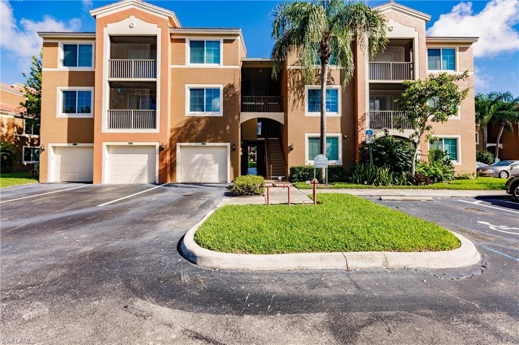1230 Reserve Way, Unit 302 Naples, FL 34105 - Photo 2 of 28 a front view of a house with a yard