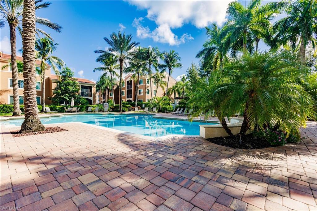 1230 Reserve Way, Unit 302 Naples, FL 34105 - Photo 21 of 28 a view of swimming pool with a yard