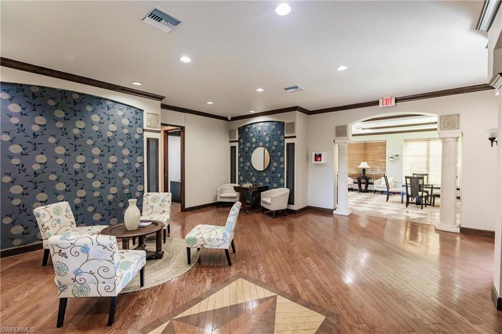 1230 Reserve Way, Unit 302 Naples, FL 34105 - Photo 24 of 28 a living room with furniture and a large window
