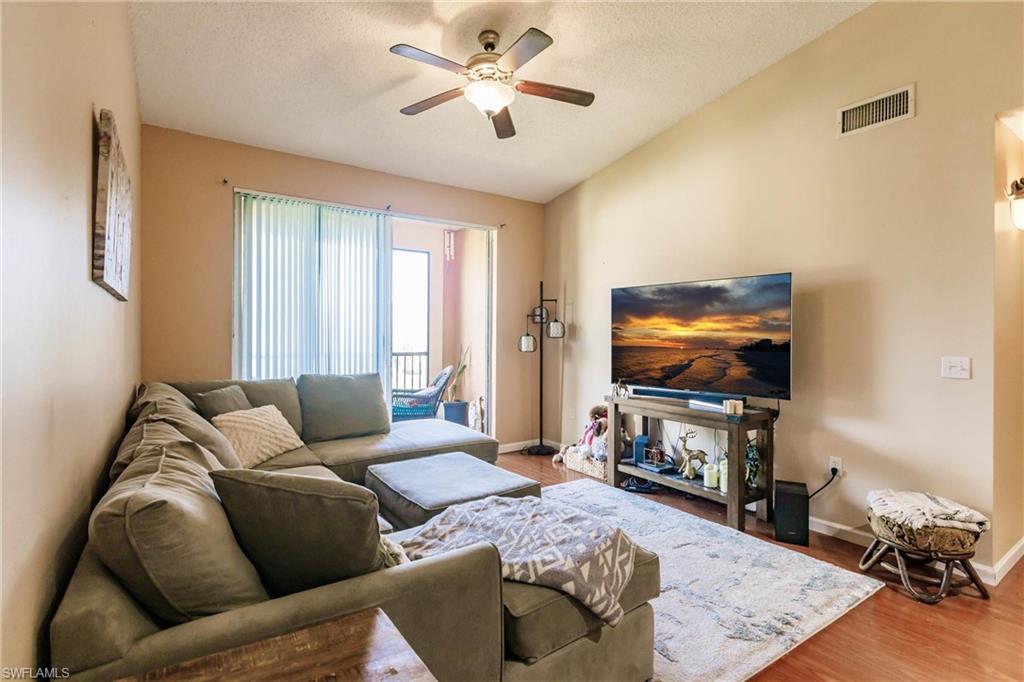 1230 Reserve Way, Unit 302 Naples, FL 34105 - Photo 3 of 28 a living room with furniture and a flat screen tv