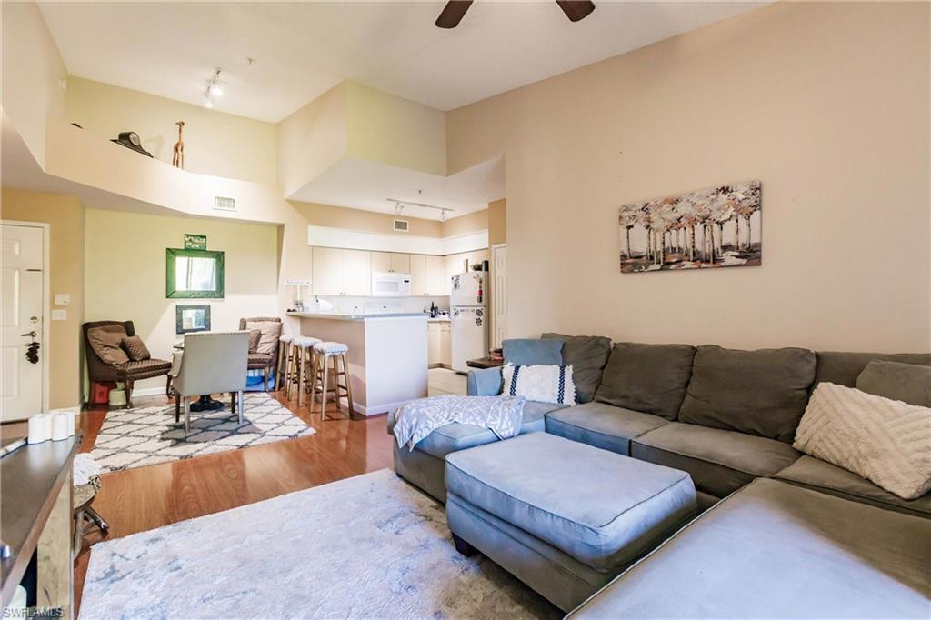 1230 Reserve Way, Unit 302 Naples, FL 34105 - Photo 5 of 28 a living room with furniture and a couch