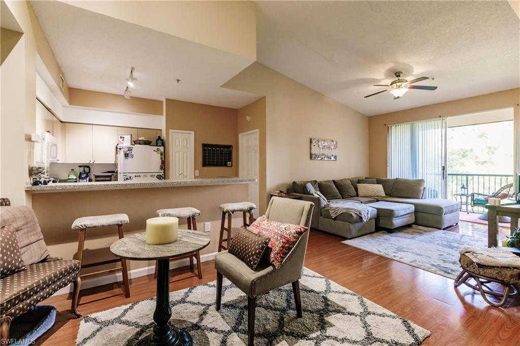 1230 Reserve Way, Unit 302 Naples, FL 34105 - Photo 8 of 28 a living room with furniture and a large window