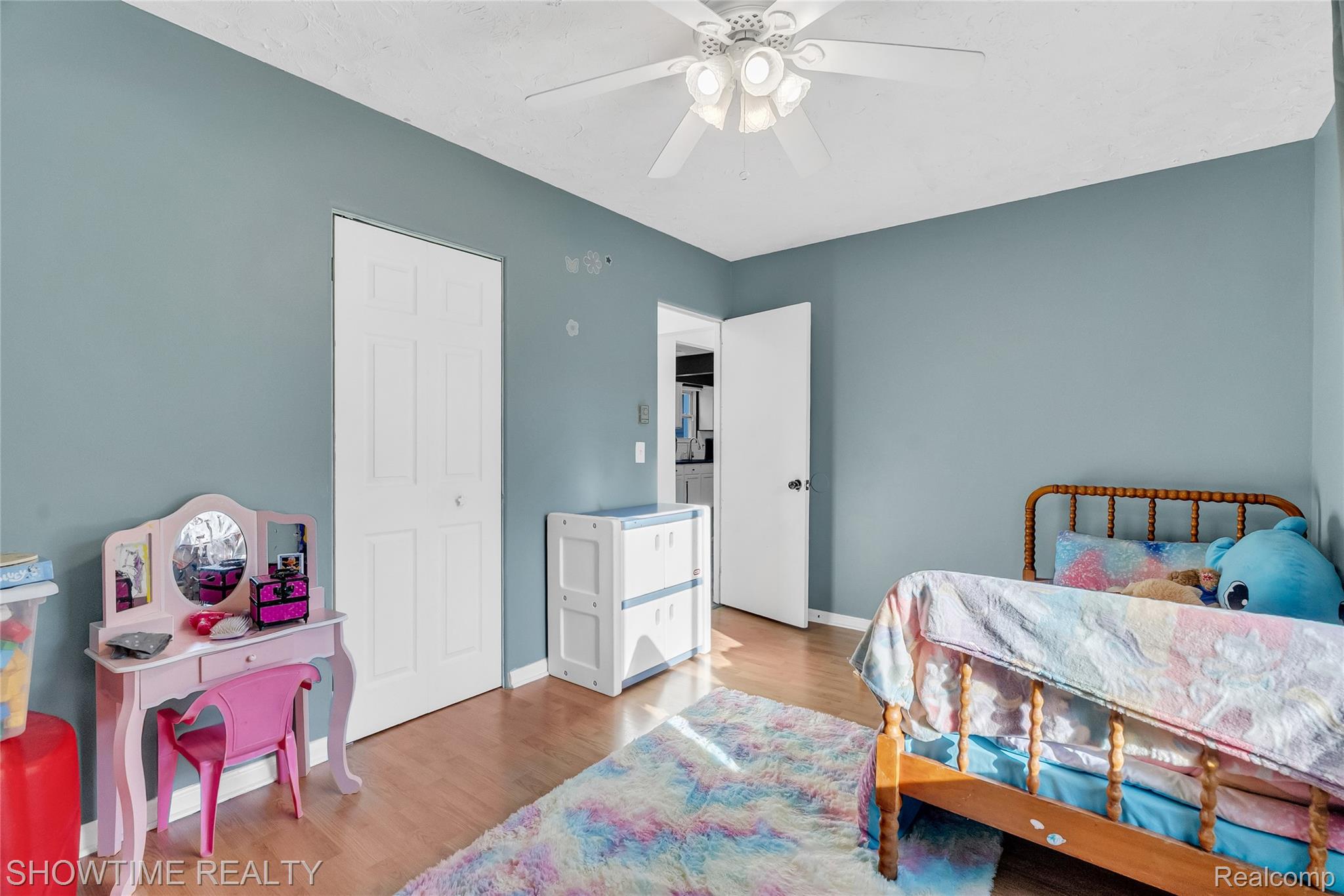 3444 Maple Street Port Huron, MI 48060 - Photo 21 of 30 Interior room featuring wood-finish flooring, light blue wall paint, and a ceiling fan with integrated lighting