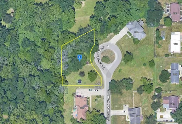 an aerial view of a house with a backyard space