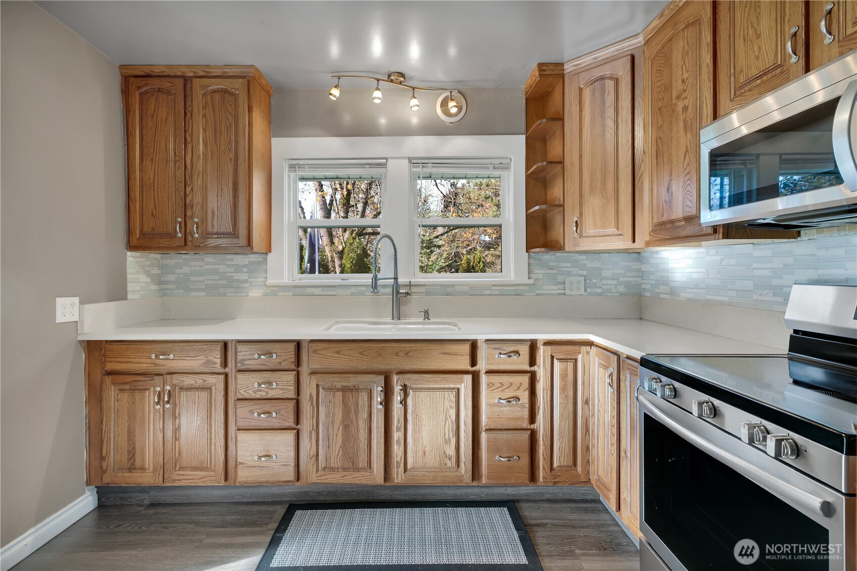 1547 Southwest Myrtle Street Seattle, WA 98106 - Photo 11 of 40 a kitchen with stainless steel appliances granite countertop a stove a sink and a microwave