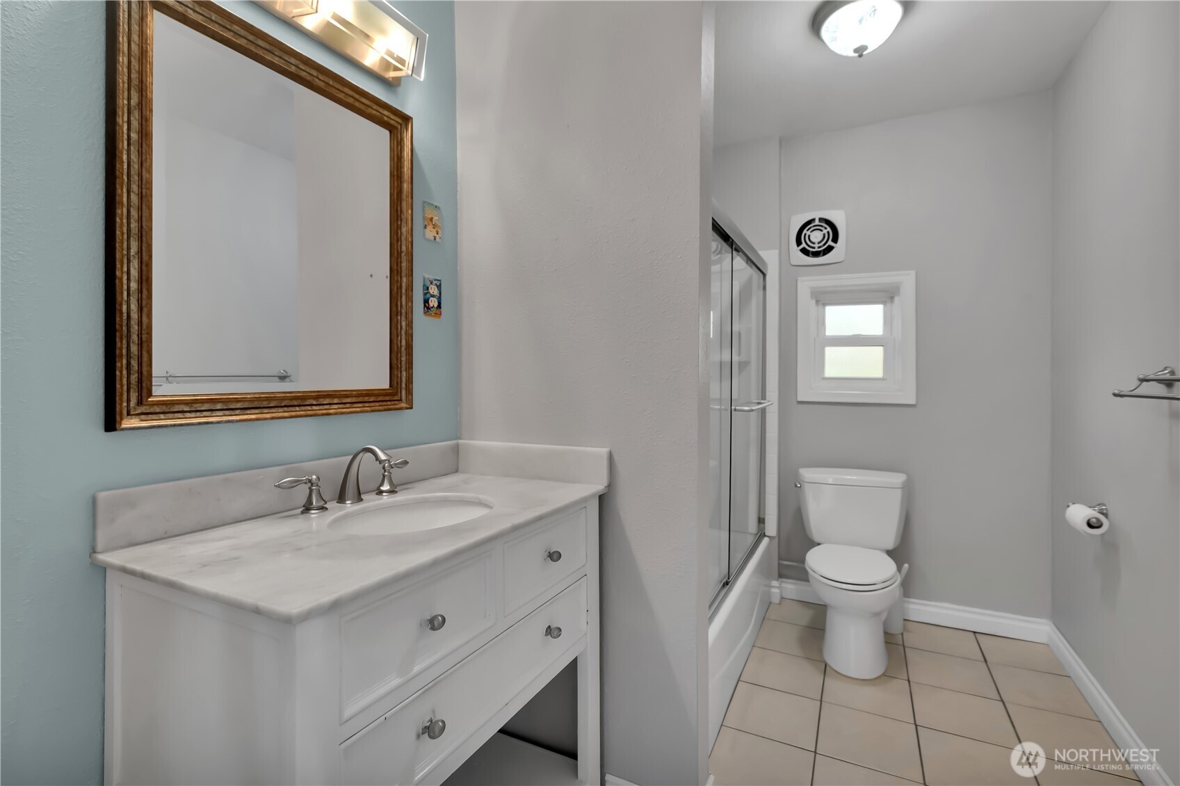 1547 Southwest Myrtle Street Seattle, WA 98106 - Photo 12 of 40 a bathroom with a toilet sink and mirror