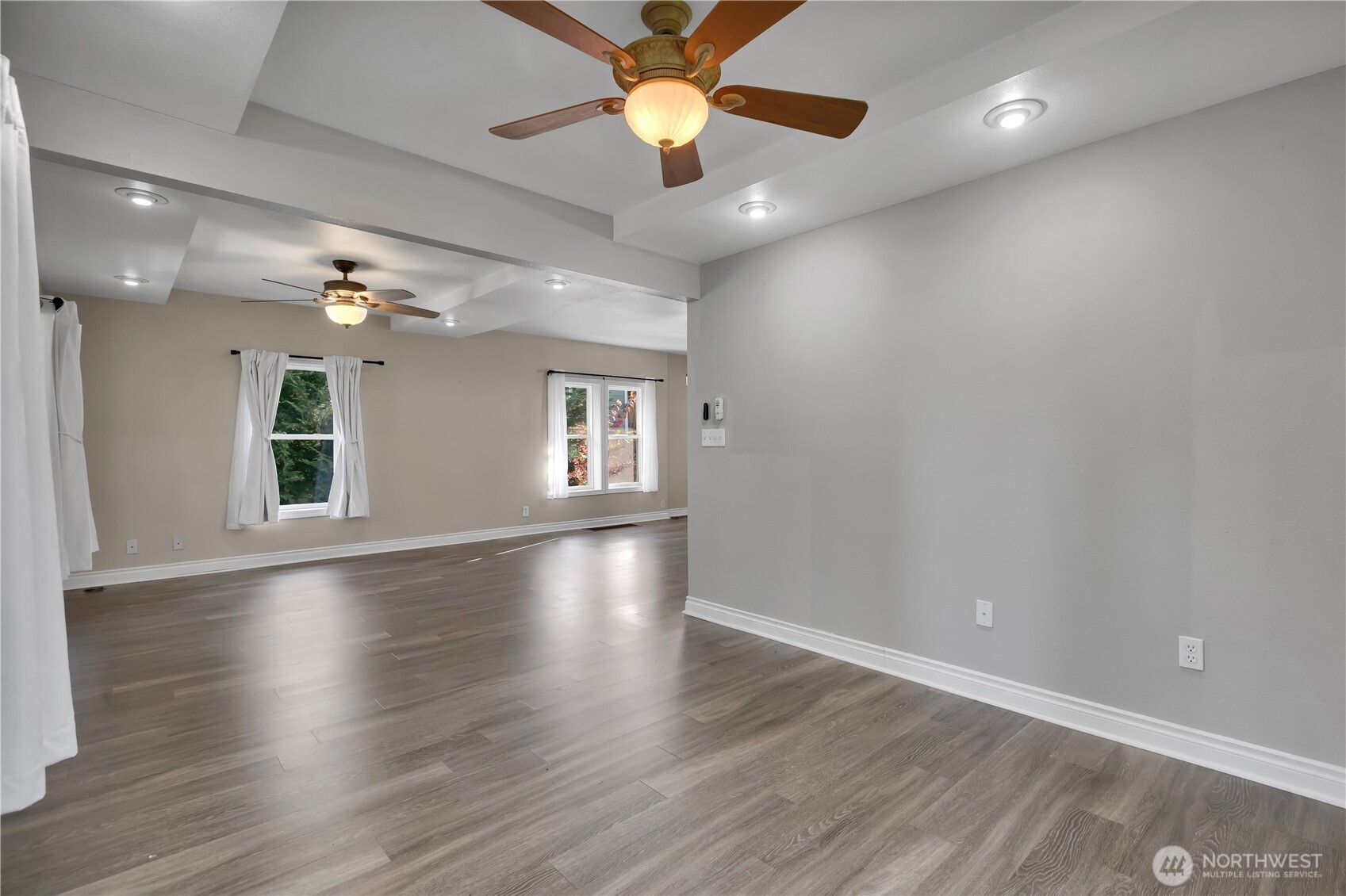 1547 Southwest Myrtle Street Seattle, WA 98106 - Photo 13 of 40 a view of an empty room with window and wooden floor