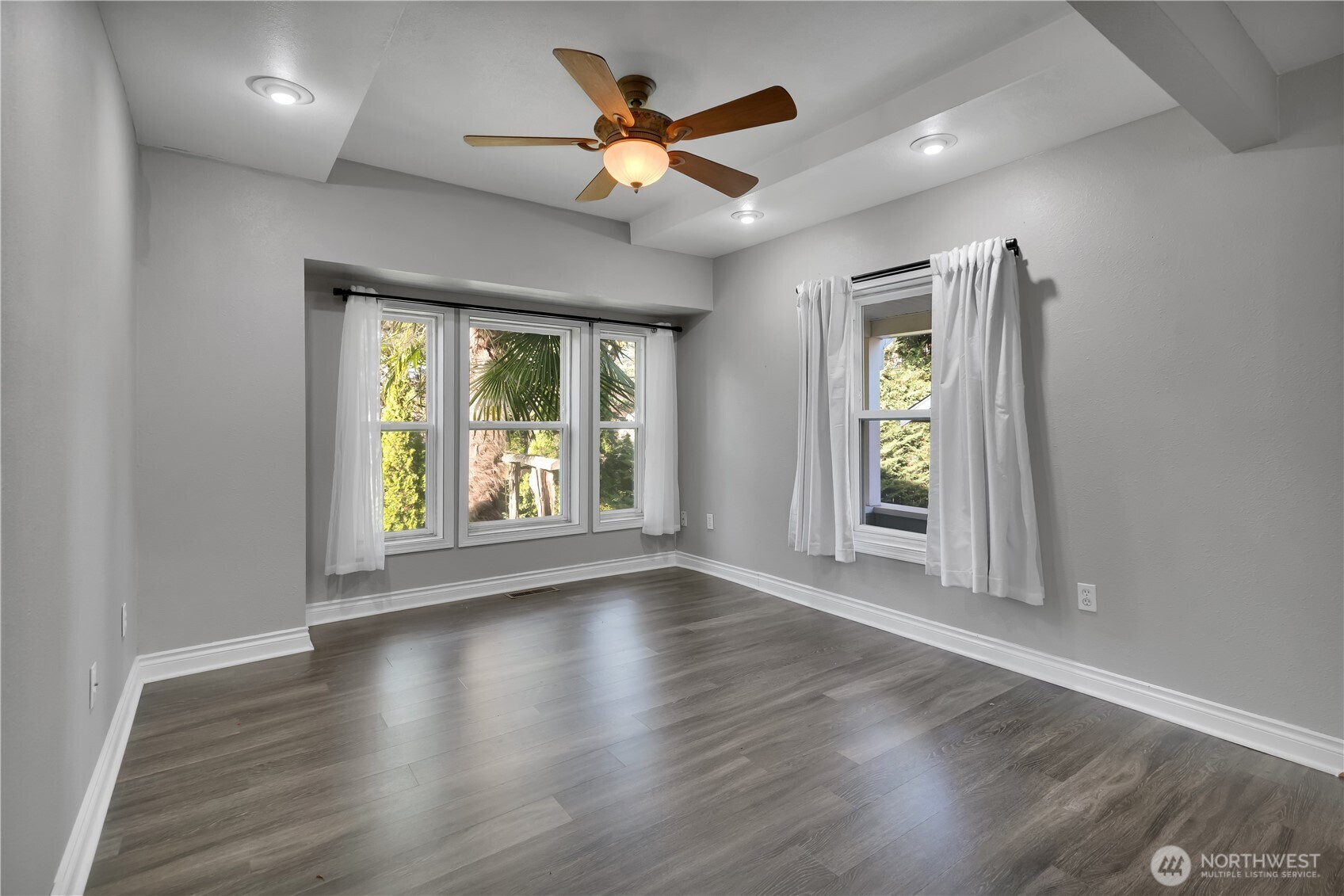 1547 Southwest Myrtle Street Seattle, WA 98106 - Photo 14 of 40 an empty room with wooden floor and windows