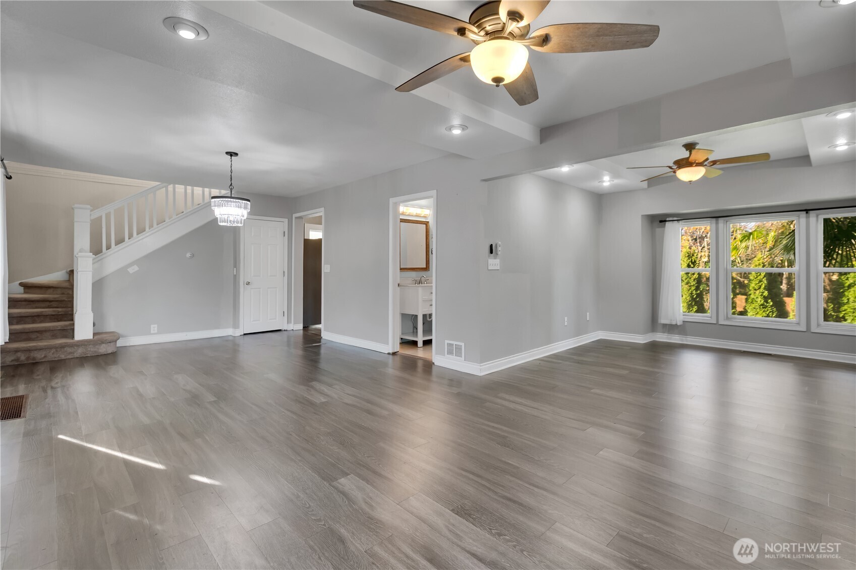 1547 Southwest Myrtle Street Seattle, WA 98106 - Photo 15 of 40 an empty room with wooden floor fan and windows