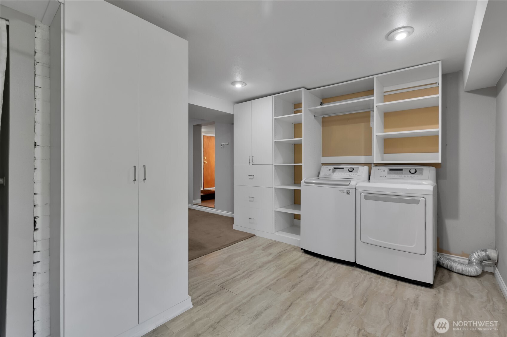 1547 Southwest Myrtle Street Seattle, WA 98106 - Photo 22 of 40 a view of an empty room with wooden floor and cabinet