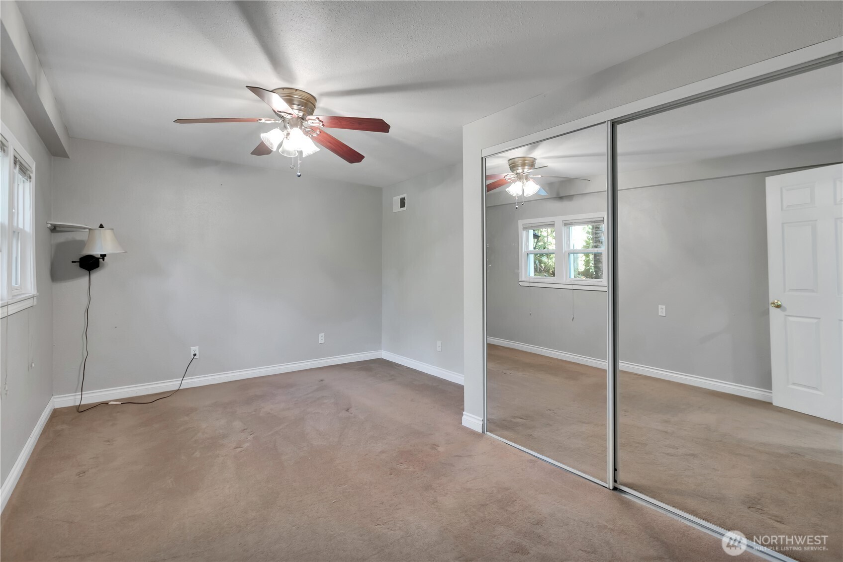 1547 Southwest Myrtle Street Seattle, WA 98106 - Photo 23 of 40 an empty room with windows and fan