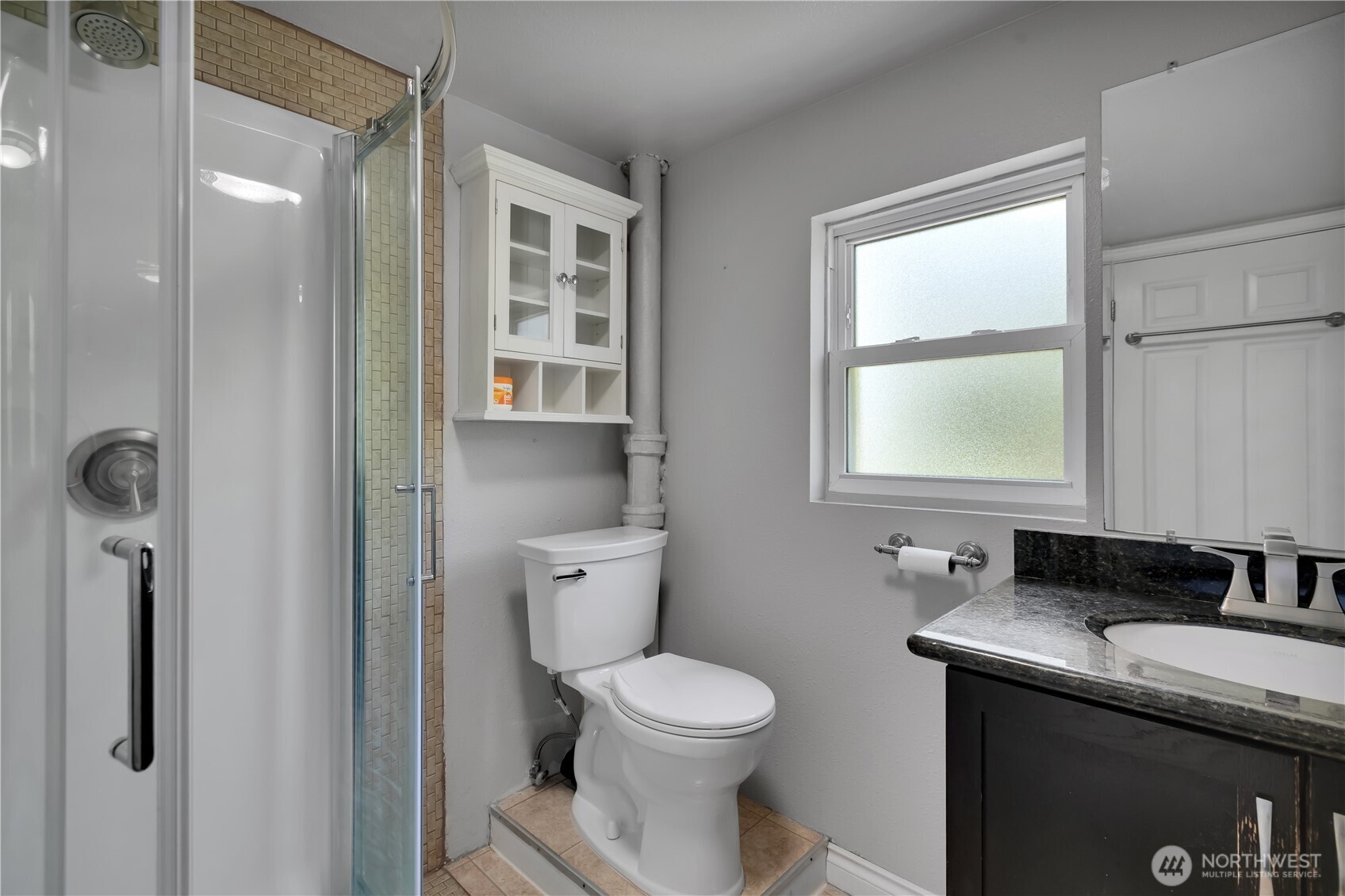 1547 Southwest Myrtle Street Seattle, WA 98106 - Photo 26 of 40 a bathroom with a granite countertop sink toilet and shower
