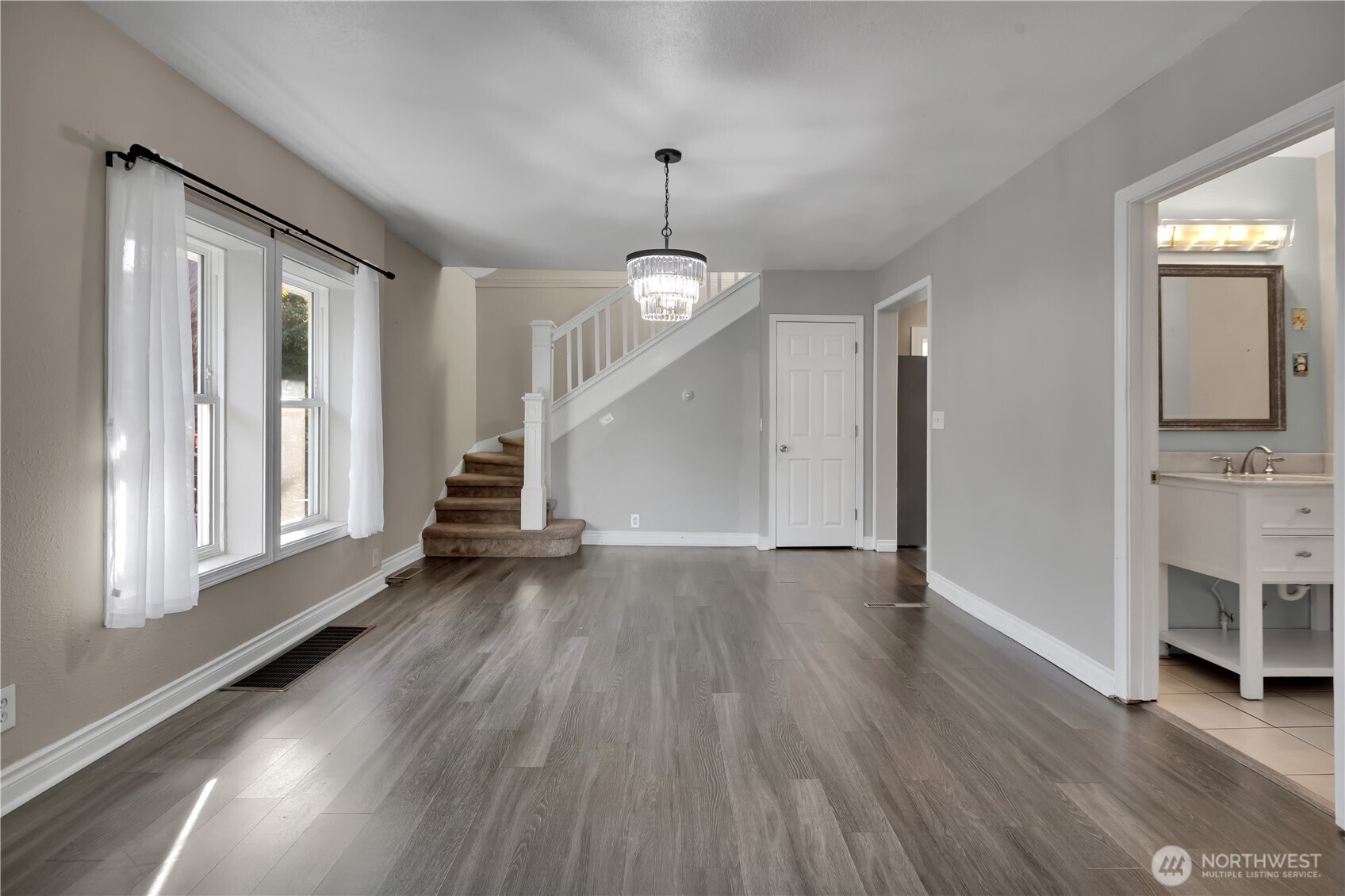 1547 Southwest Myrtle Street Seattle, WA 98106 - Photo 6 of 40 a view of a livingroom with wooden floor and a window