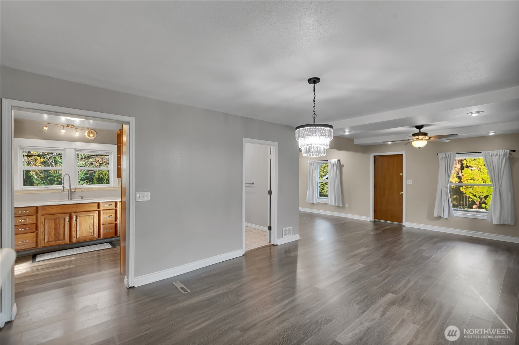 1547 Southwest Myrtle Street Seattle, WA 98106 - Photo 7 of 40 an empty room with wooden floor and windows