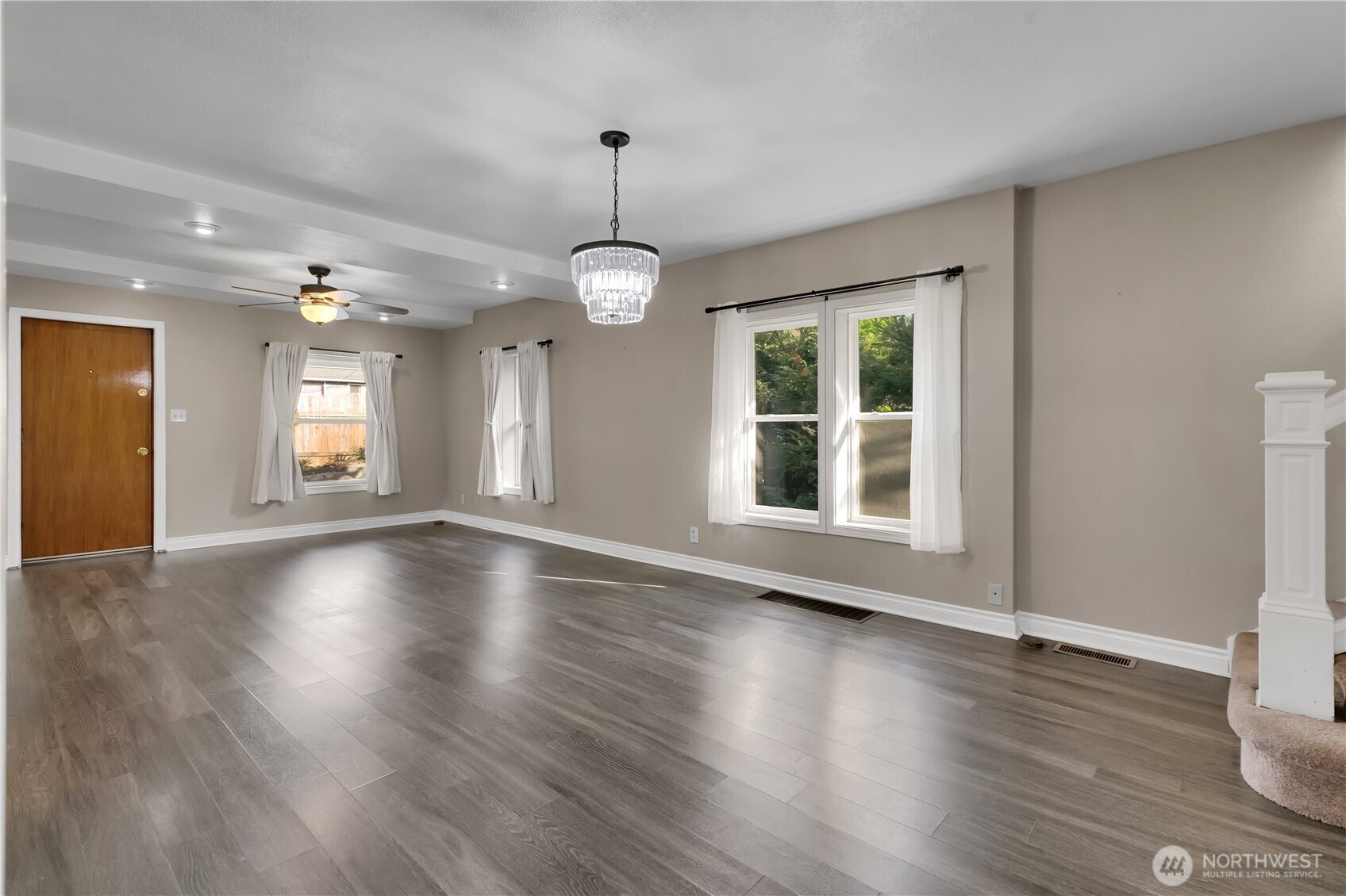 1547 Southwest Myrtle Street Seattle, WA 98106 - Photo 8 of 40 a view of an empty room with wooden floor and a window
