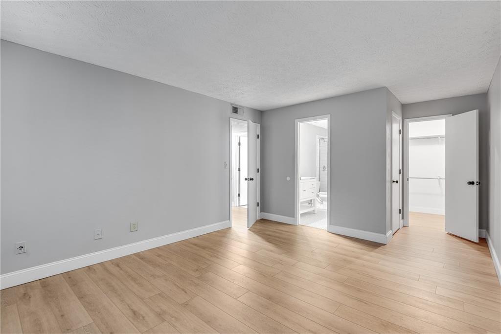 1214 Wynnes Ridge Circle Southeast Marietta, GA 30067 - Photo 15 of 24 a view of an empty room with wooden floor and a window