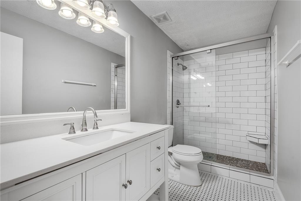 1214 Wynnes Ridge Circle Southeast Marietta, GA 30067 - Photo 16 of 24 a bathroom with a sink a toilet and shower