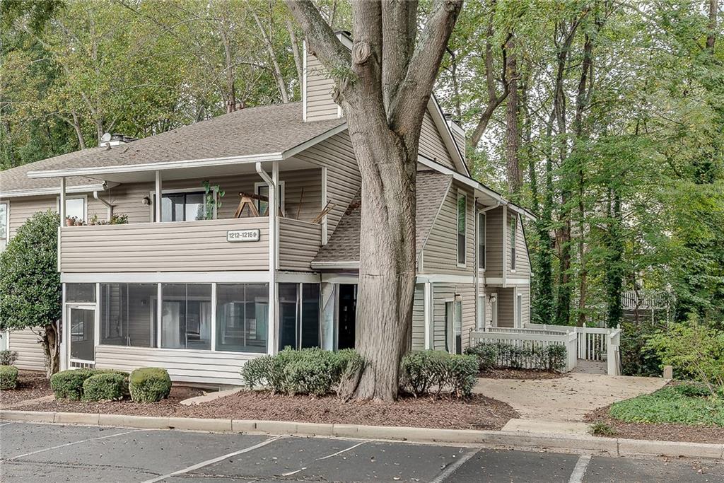 1214 Wynnes Ridge Circle Southeast Marietta, GA 30067 - Photo 20 of 24 a front view of a house with a yard and garage