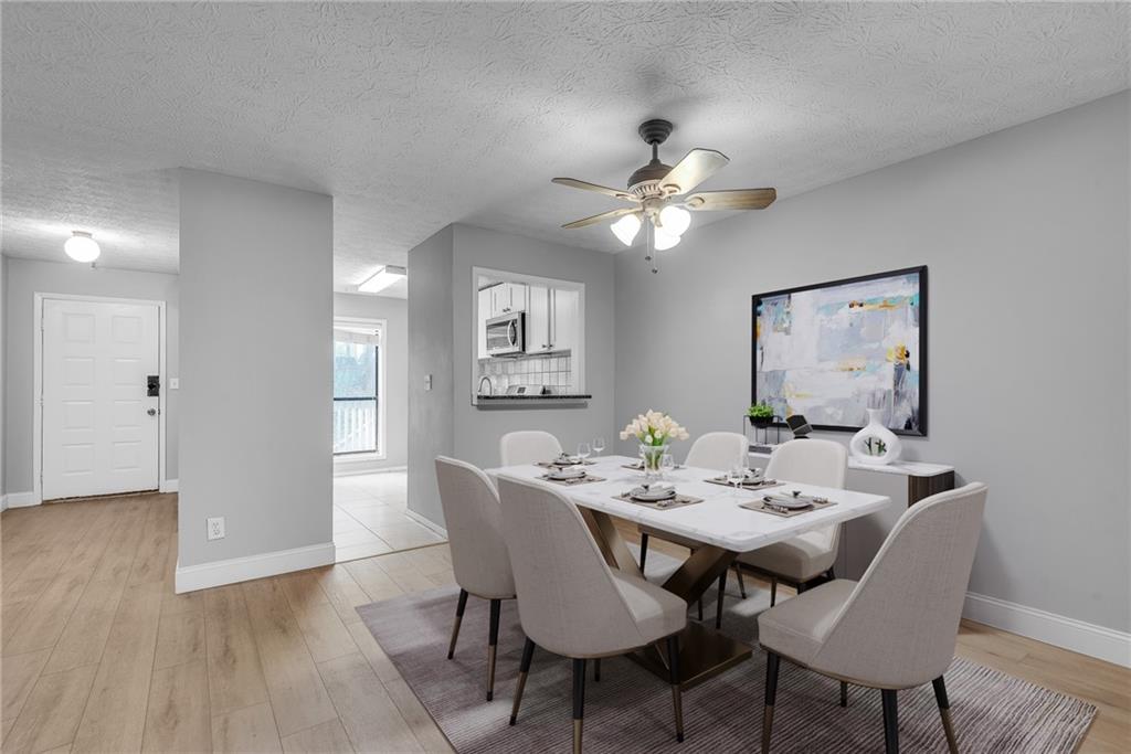 1214 Wynnes Ridge Circle Southeast Marietta, GA 30067 - Photo 3 of 24 a view of a dining room with a table and chairs