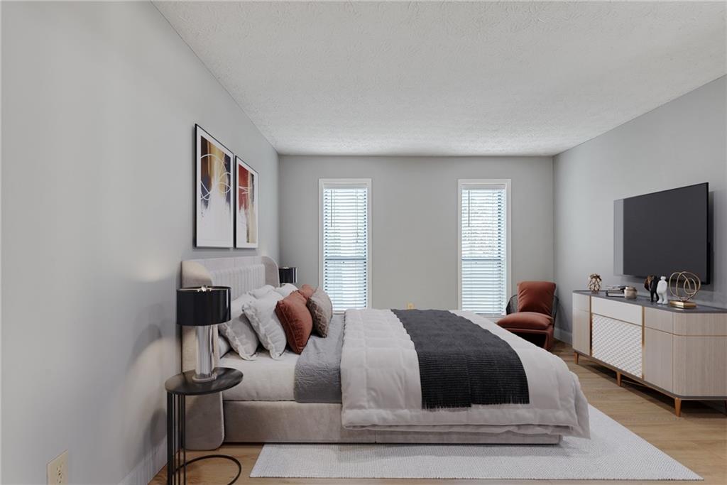 1214 Wynnes Ridge Circle Southeast Marietta, GA 30067 - Photo 5 of 24 a bedroom with a bed and flat screen tv