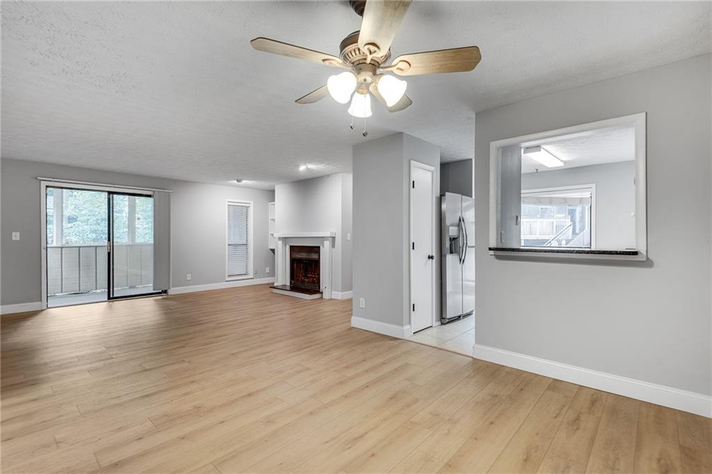 1214 Wynnes Ridge Circle Southeast Marietta, GA 30067 - Photo 7 of 24 a view of an empty room with window and wooden floor