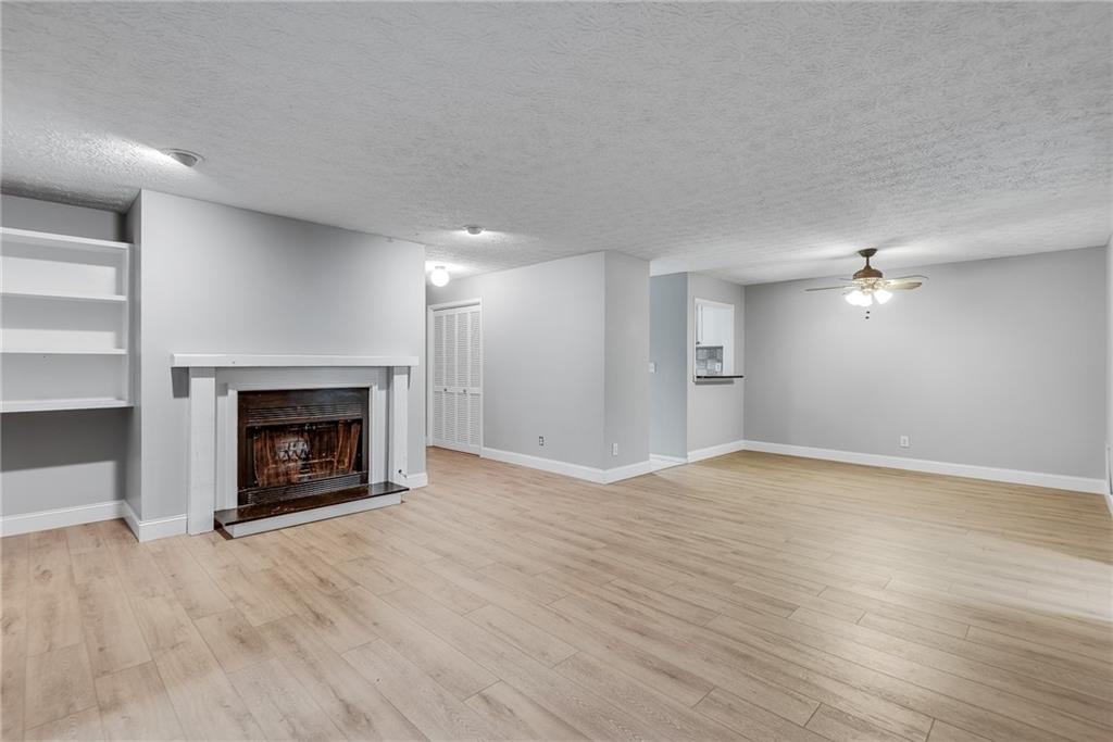1214 Wynnes Ridge Circle Southeast Marietta, GA 30067 - Photo 8 of 24 a view of an empty room with a fireplace and a window