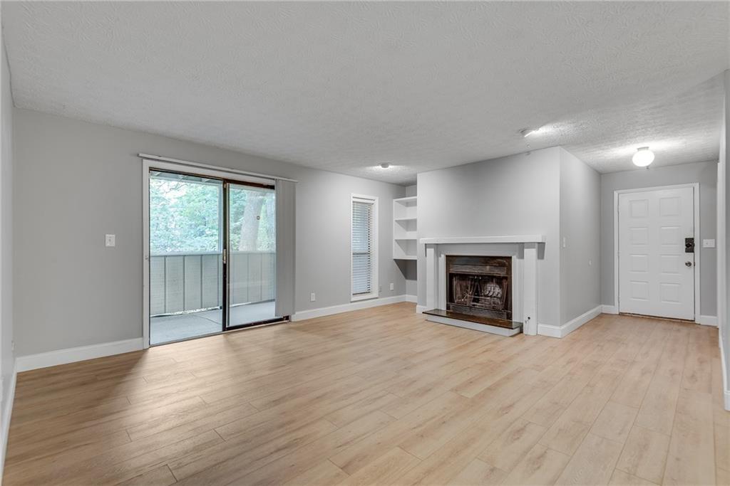 1214 Wynnes Ridge Circle Southeast Marietta, GA 30067 - Photo 9 of 24 a view of an empty room with a fireplace and a window