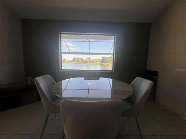 a dining room with furniture and a window