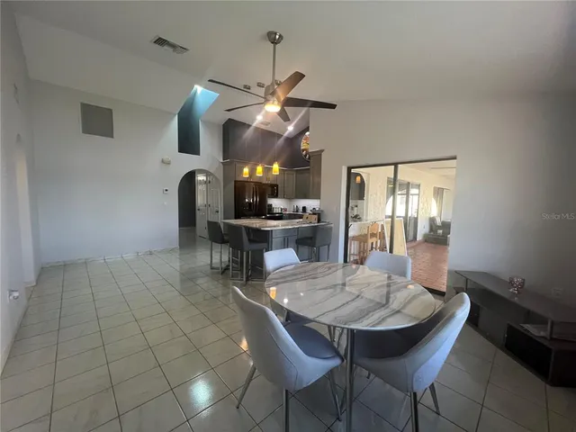a room with a table chairs and a chandelier