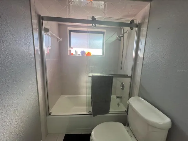 a bathroom with a sink a toilet a mirror and vanity